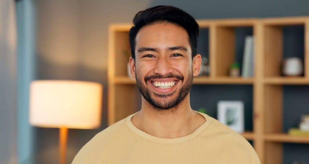 Happy,,Portrait,And,Asian,Man,In,A,Living,Room,At