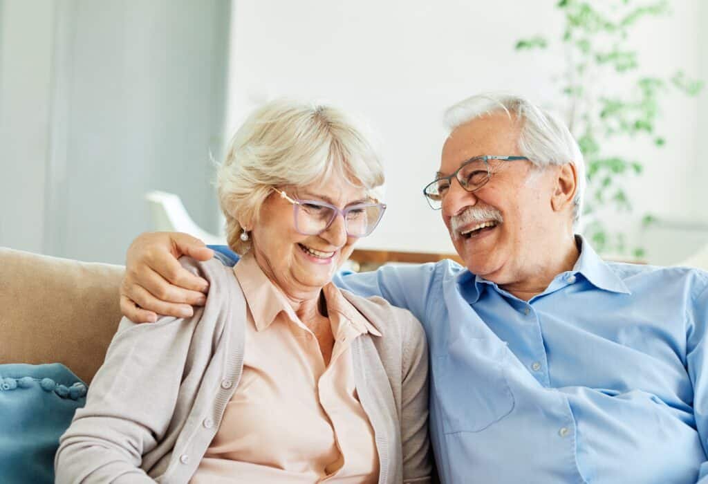 Portrait,Of,A,Happy,Senior,Couple,Embracing,Talking,And,Drinking